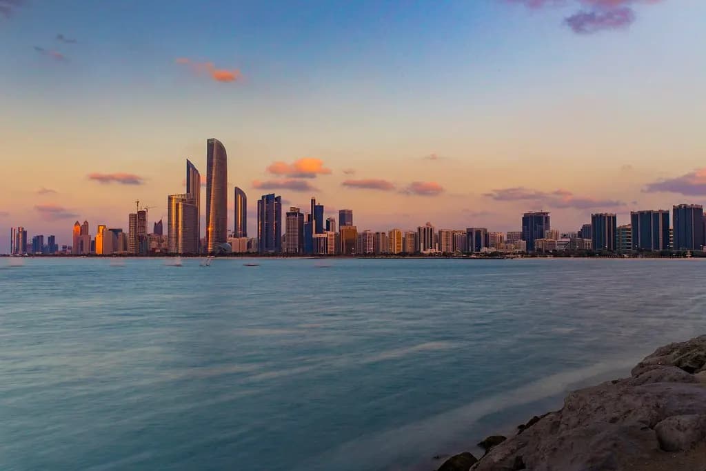 Abu Dhabi city skyline with high-rise towers under a clearing sky