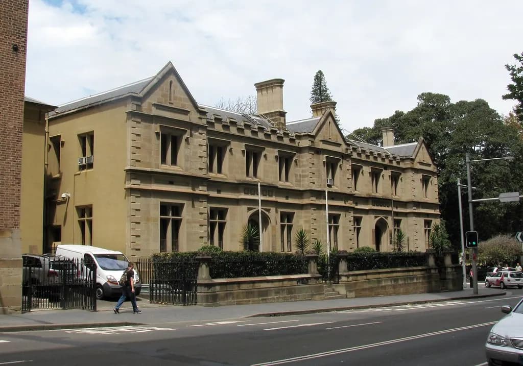 Sandstone Supreme Court building on a Sydney street