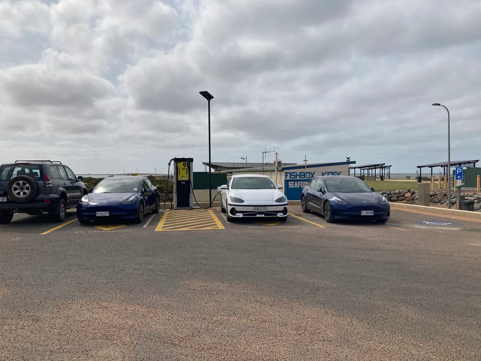 Electric cars plugged in at a roadside charging station in Cowell, South Australia