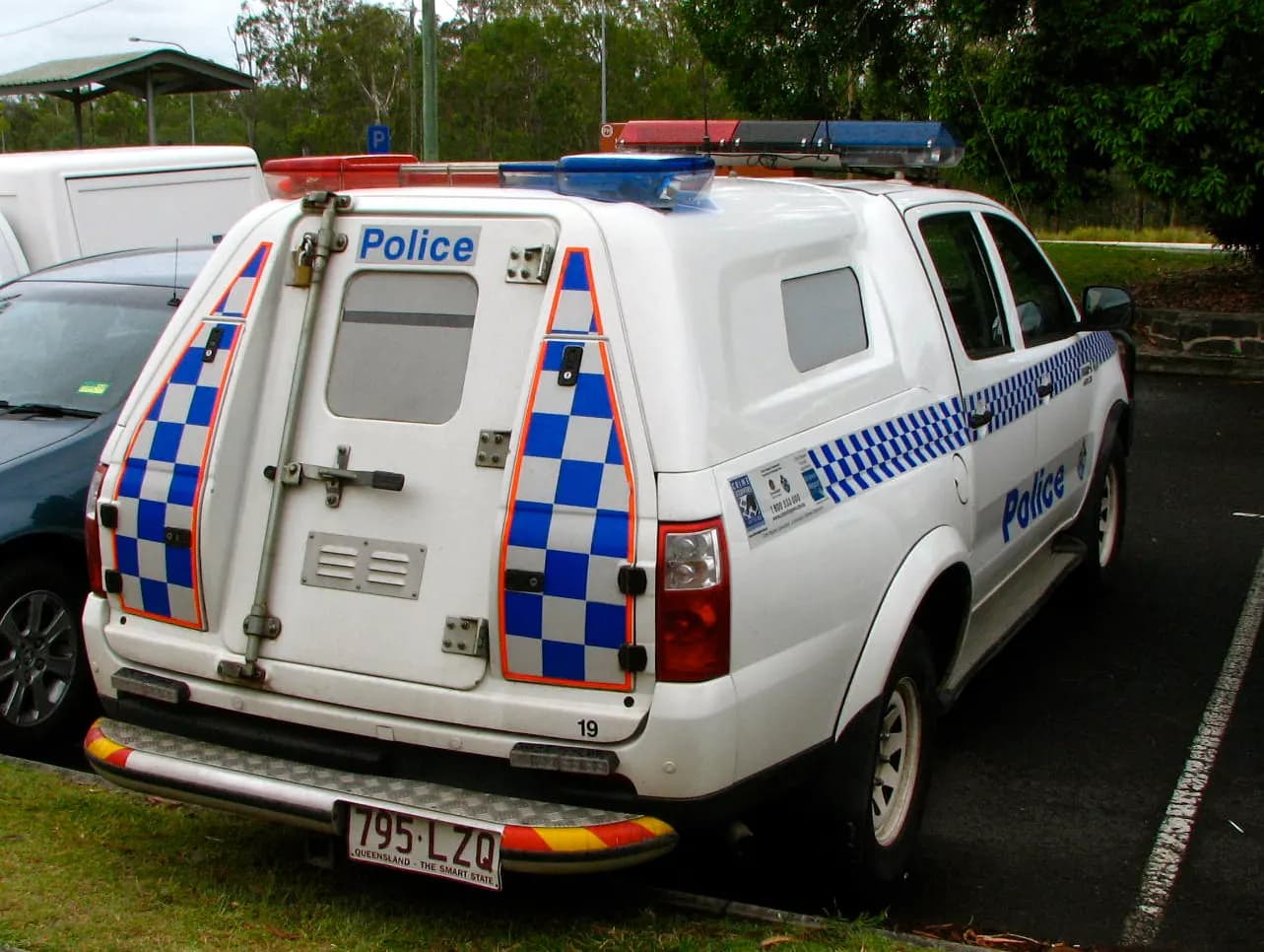 Dual-cab work ute with a caged tray canopy for tools