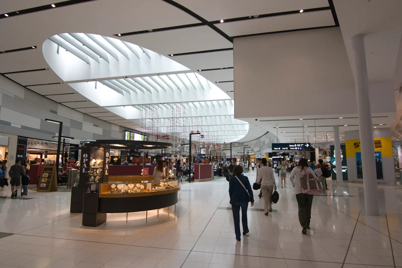 Travellers walking through the airside international departures hall at Sydney Kingsford Smith Airport