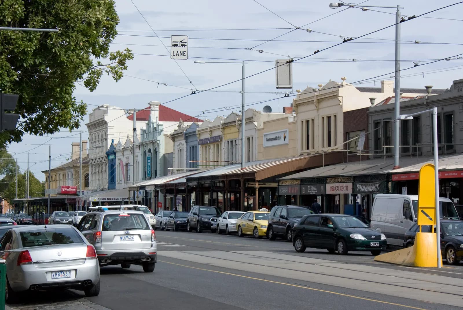 Row of small shops and cafes along Errol Street shopping strip in North Melbourne