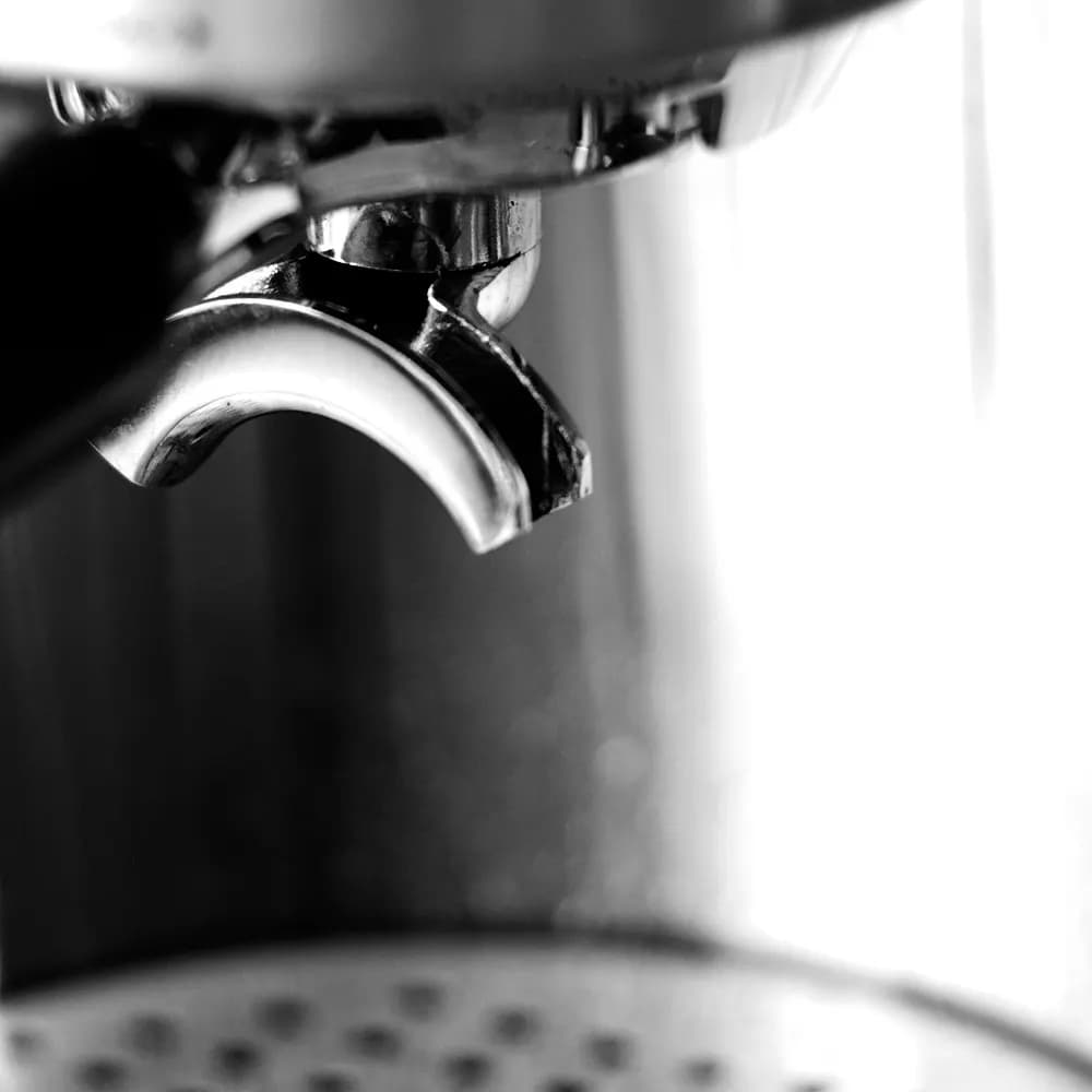 Close-up of the spout of a portafilter on an espresso machine