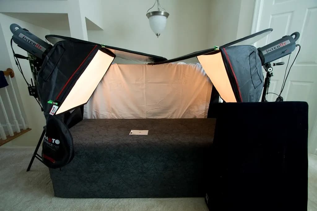 A home product photography set-up with two softbox lights either side of a white backdrop