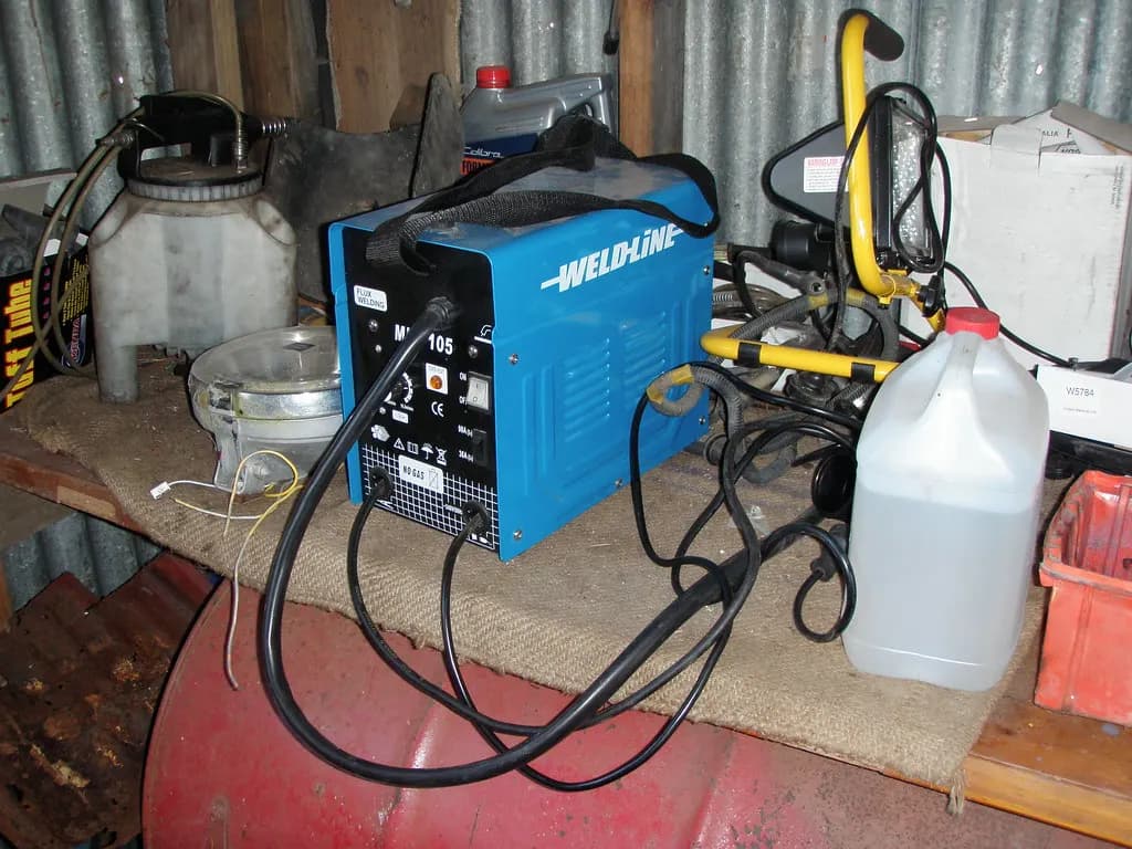 MIG welding machine with its gas bottle and welding torch in a small workshop