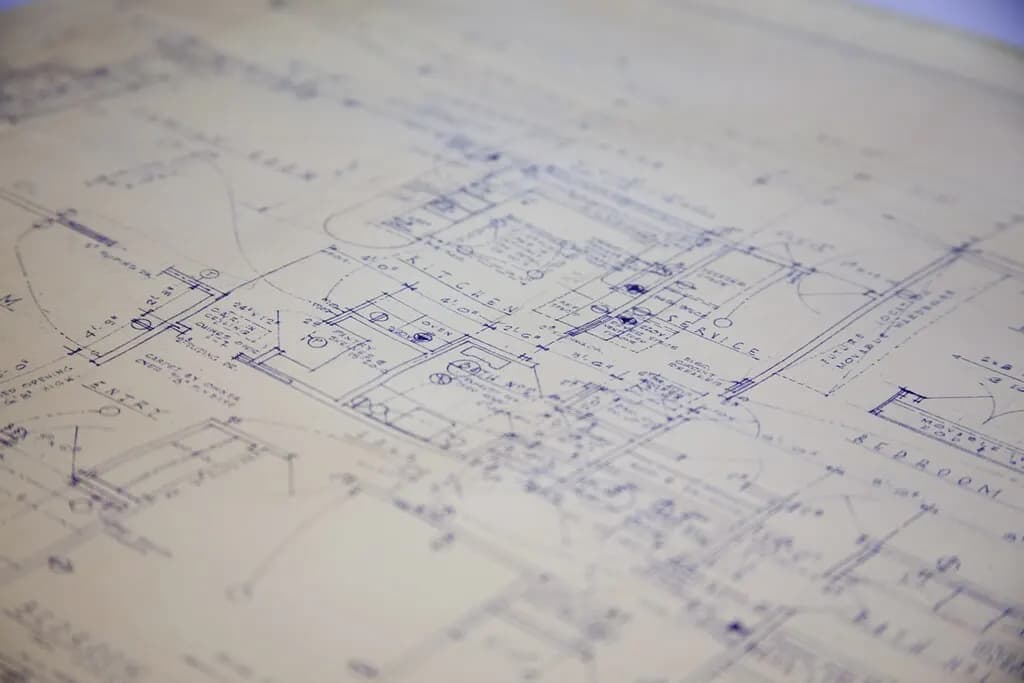 Close-up of a printed building blueprint with floor plan lines and dimensions