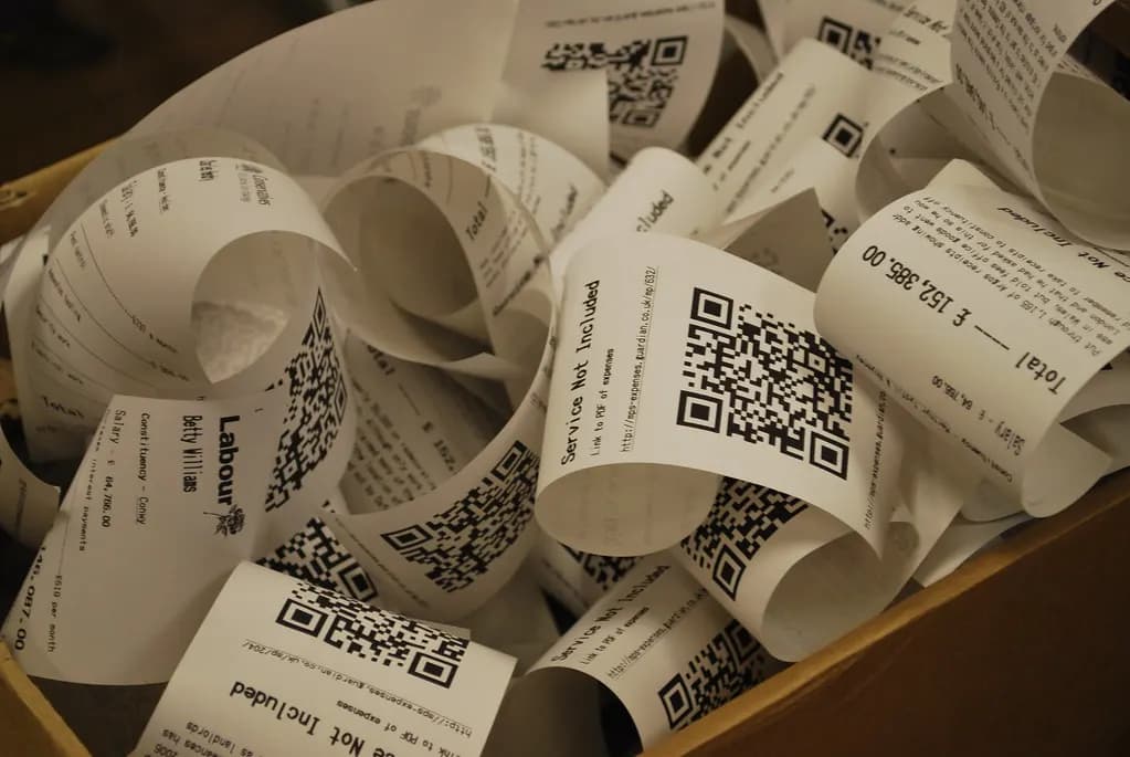 Close-up of paper receipts printing out of a till printer