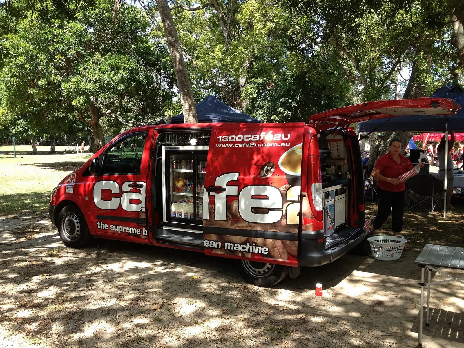 Mobile coffee van with its side doors open, serving at a park event in Australia