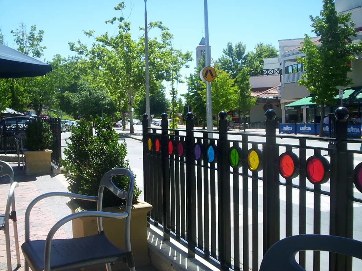 Outdoor café seating behind a fence on a street at Manuka, Canberra