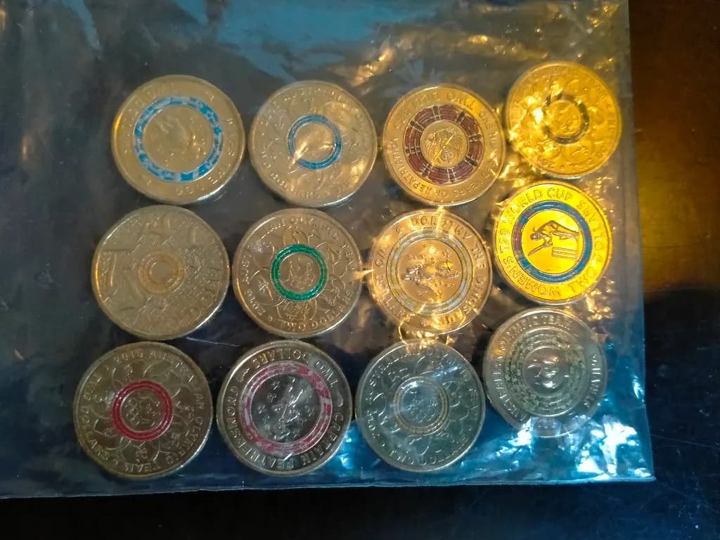 A collection of Australian two-dollar coins laid out on a table