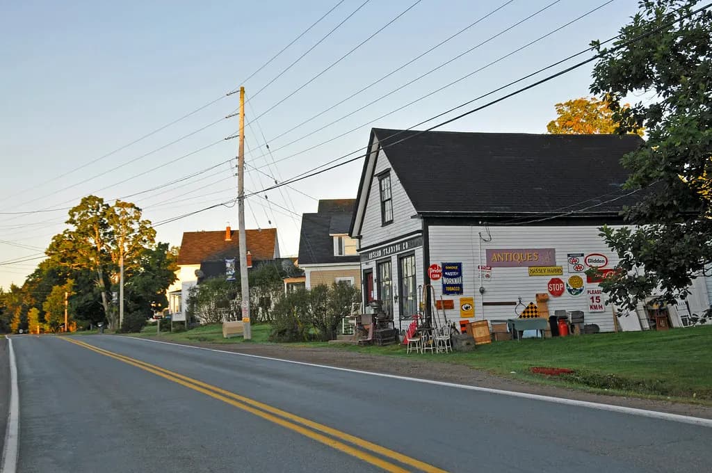 A small antiques shop beside the main road in Great Village, Nova Scotia, with vintage signs on its wall