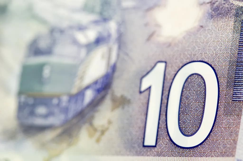 Canadian banknotes of several denominations fanned out on a table