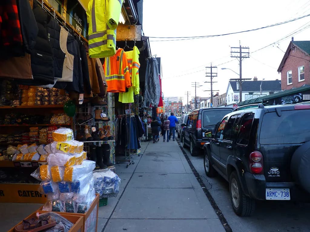 Work clothing and boots displayed outside a small shop in Kensington Market, Toronto