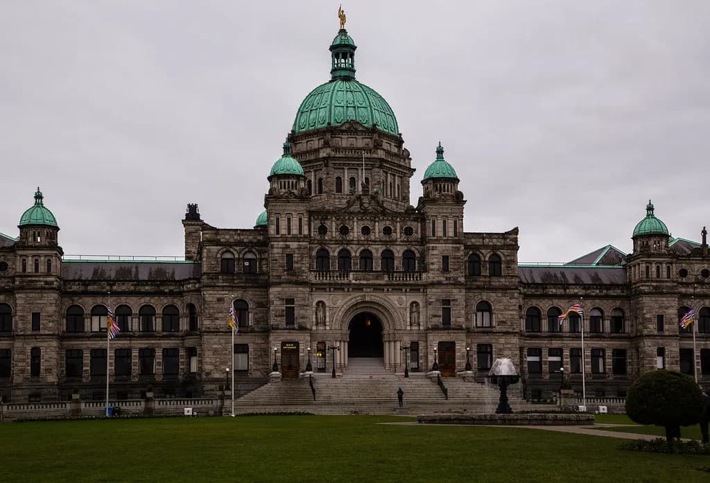 British Columbia Parliament Buildings in Victoria with a lawn and flower beds in front