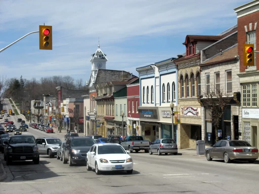 Main street of St. Marys, Ontario, lined with independent shops in 19th-century stone and brick buildings