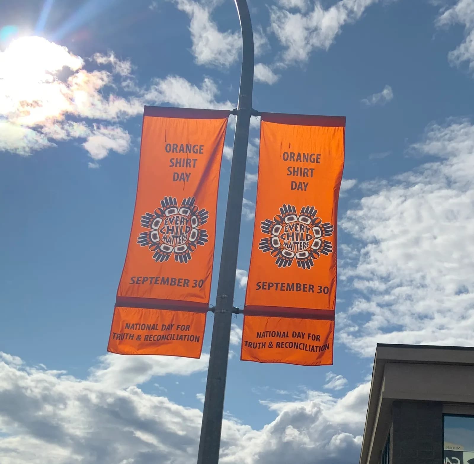 Orange street banners reading Orange Shirt Day, Every Child Matters, September 30, National Day for Truth and Reconciliation