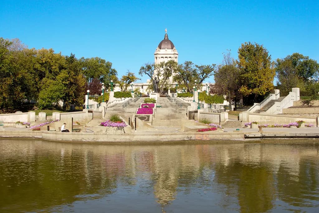 The Manitoba Legislative Building in Winnipeg seen across the Assiniboine River on a clear autumn day