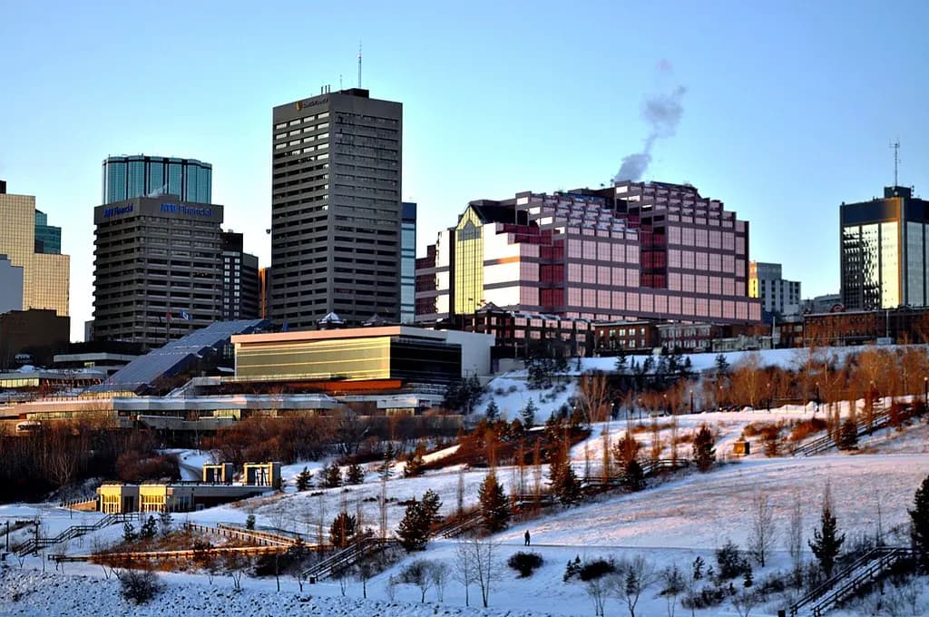 Downtown Edmonton office towers above a snow-covered river valley in winter