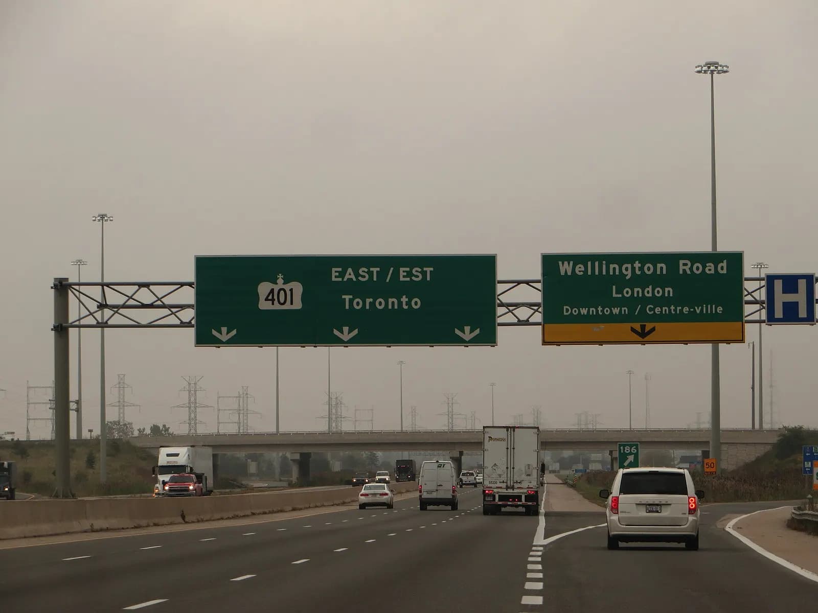 Transport trucks and cars on Highway 401 eastbound towards Toronto near London, Ontario