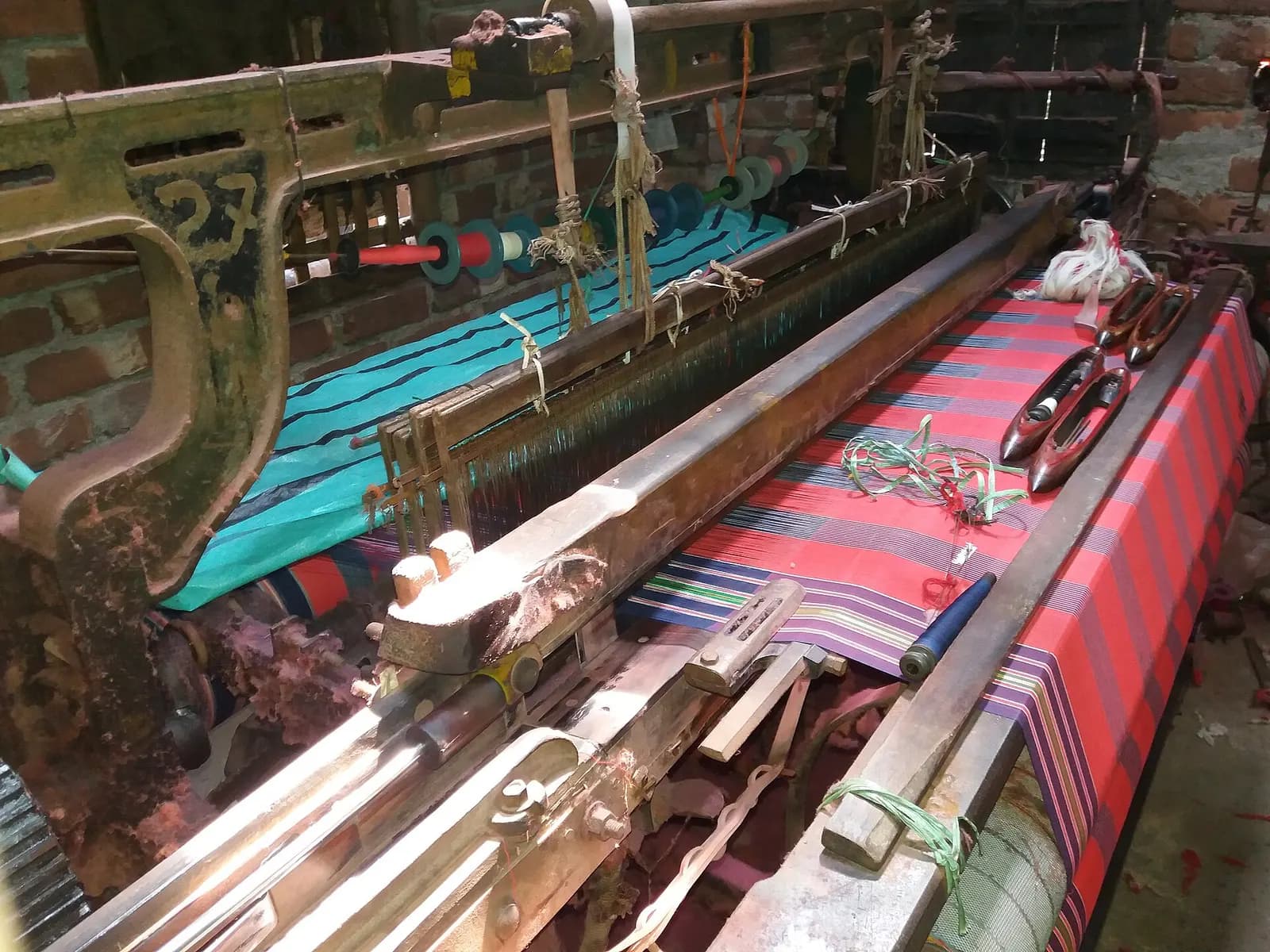 Power looms weaving striped cotton fabric in a small unit in Hooghly district, West Bengal