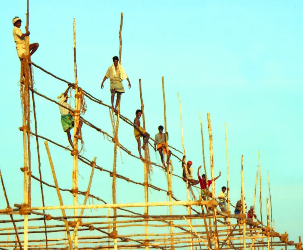 Construction workers climbing a bamboo scaffold in Kanyakumari, Tamil Nadu