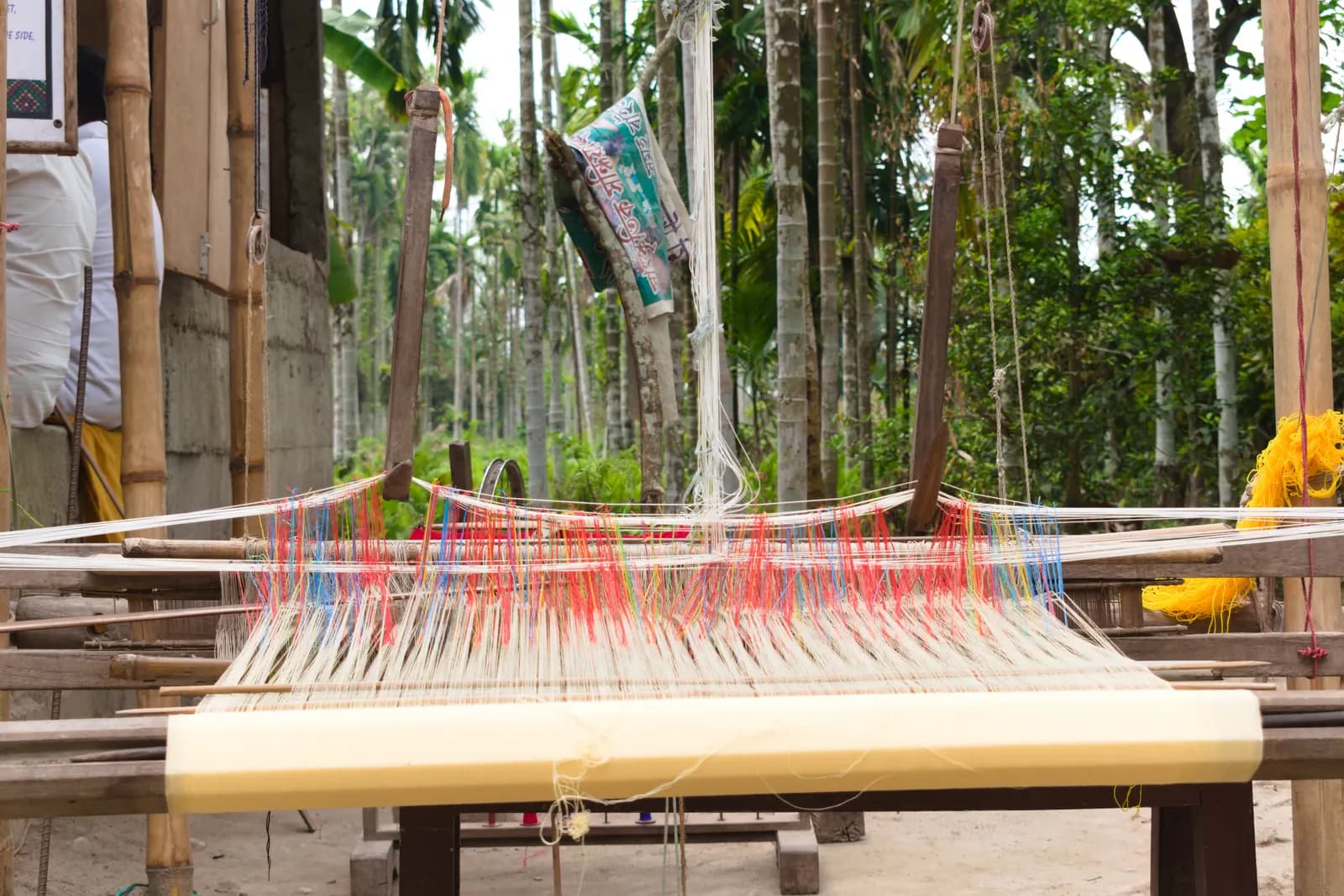 A wooden handloom with a half-woven fabric at Nameri, Assam