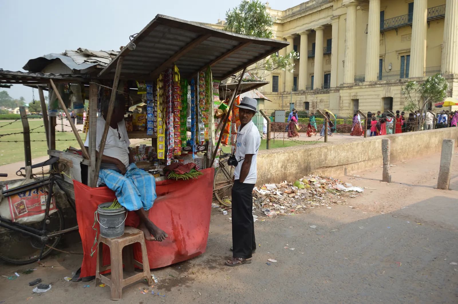 A roadside paan and tobacco kiosk with strips of pouches hanging from its roof in Murshidabad, West Bengal