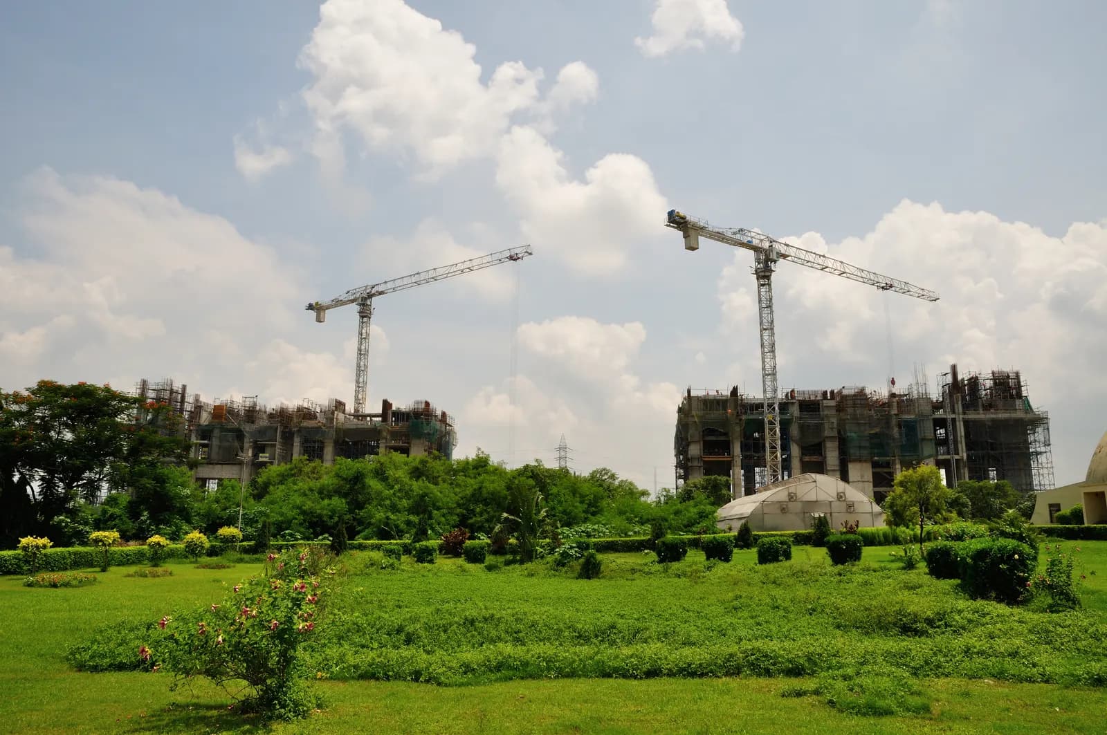 Residential apartment towers under construction with tower cranes in Kolkata