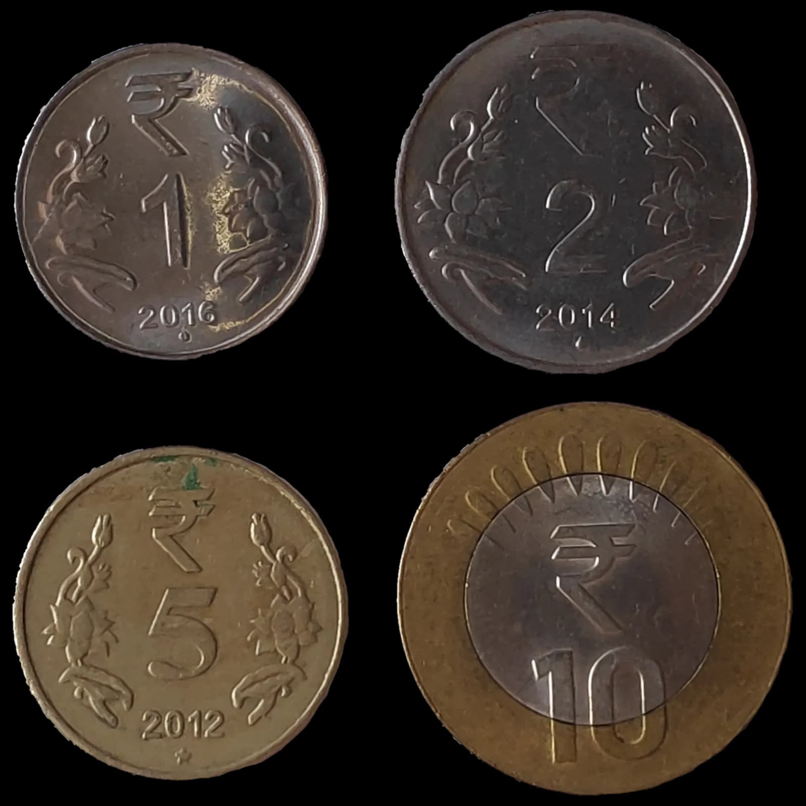 Four Indian rupee coins of 1, 2, 5 and 10 rupees showing the rupee symbol
