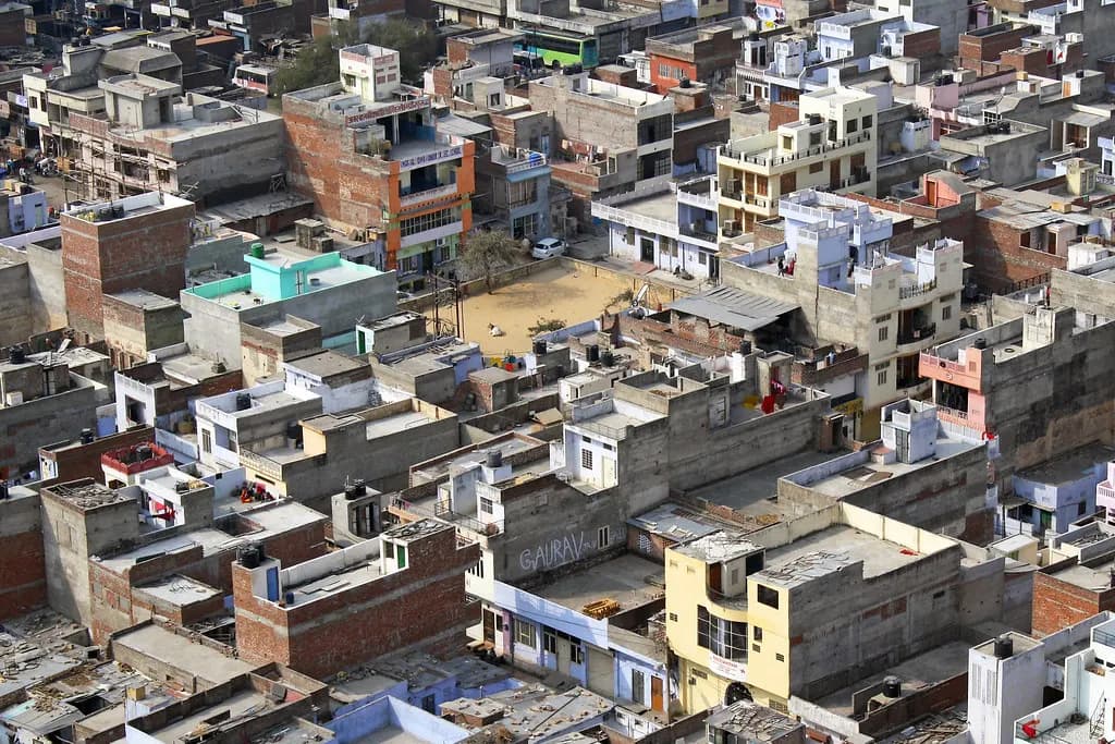 Aerial view of densely packed brick and concrete houses and small buildings in Jaipur
