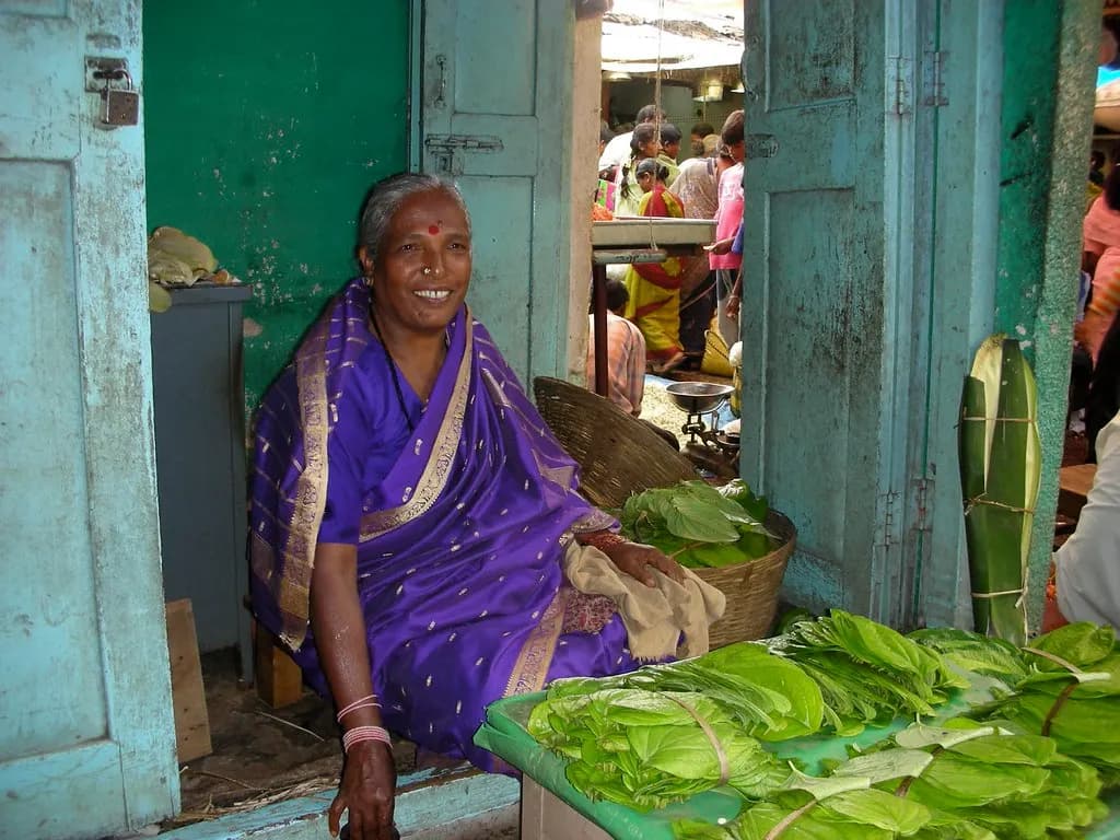 A woman selling betel leaves at her stall in a market in Mysuru, Karnataka