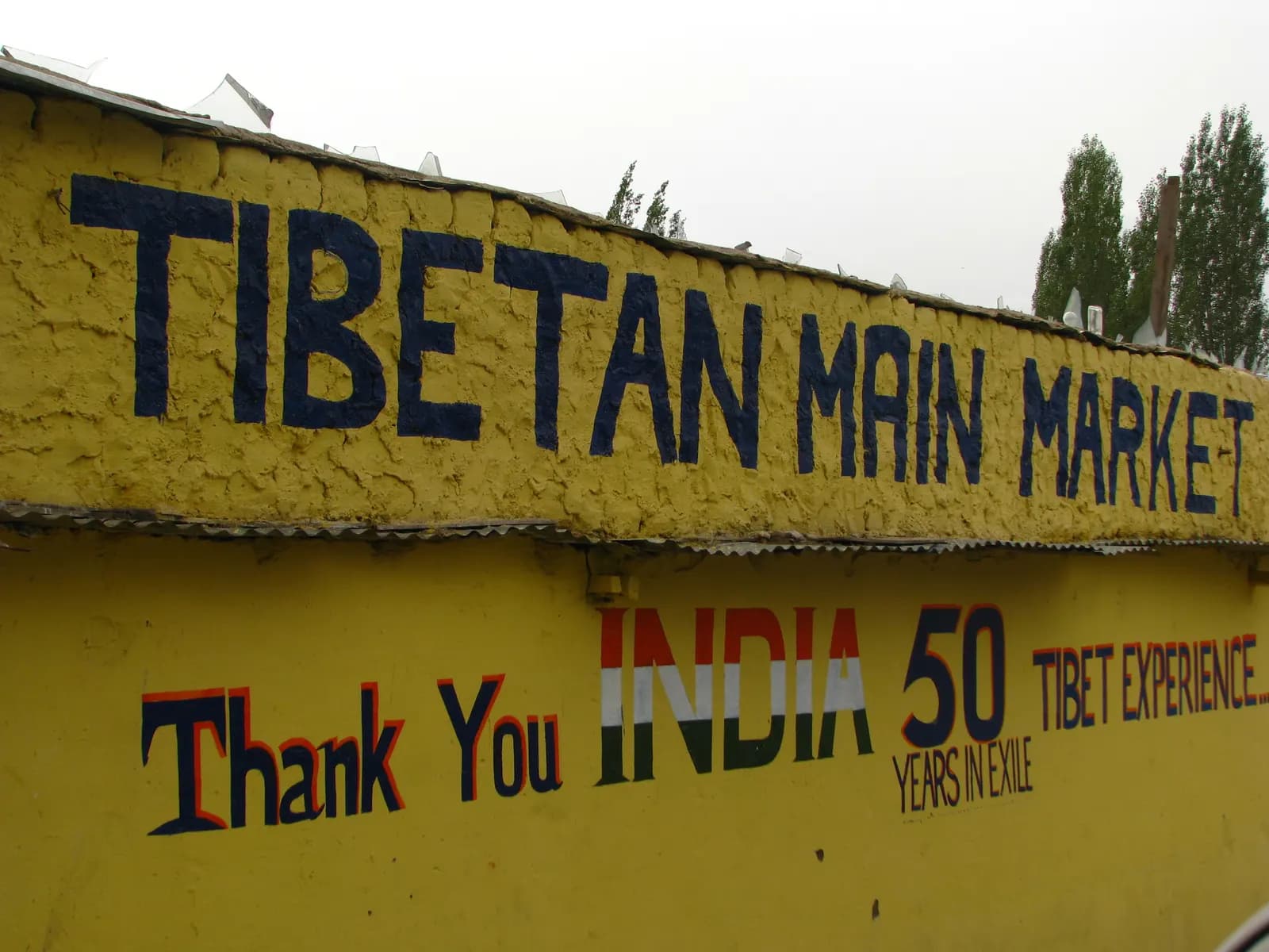Shops selling textiles and woollens in a market lane in Leh, Ladakh