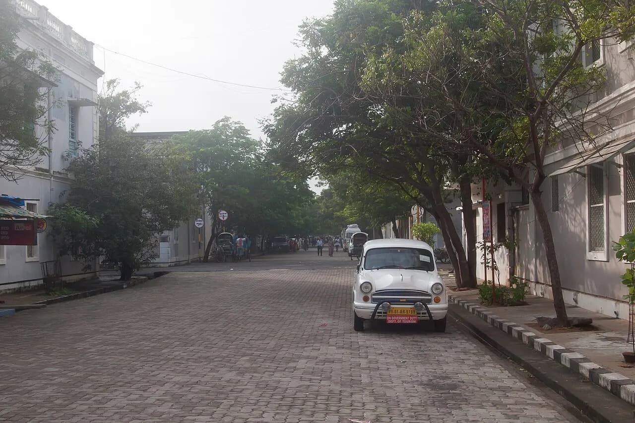 A tree-lined street of colonial buildings in Puducherry's French quarter