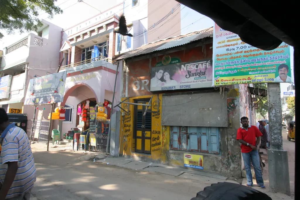 Small shops and a tea stall on a street in Puducherry town