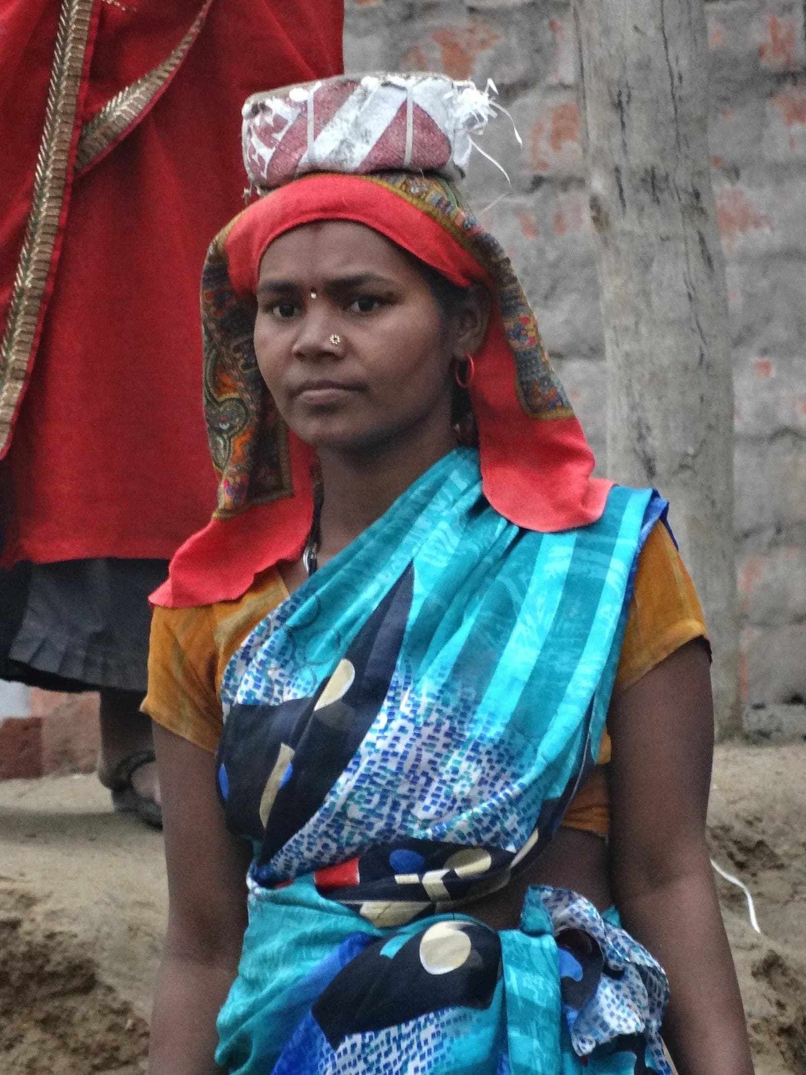 A woman construction worker with a head pad for carrying loads, in Allahabad (Prayagraj), Uttar Pradesh