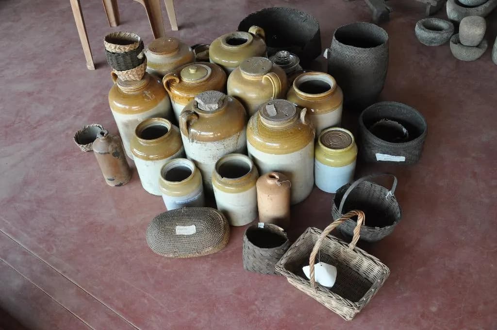 A collection of cream and brown glazed ceramic jars of different sizes, the traditional containers for storing pickles