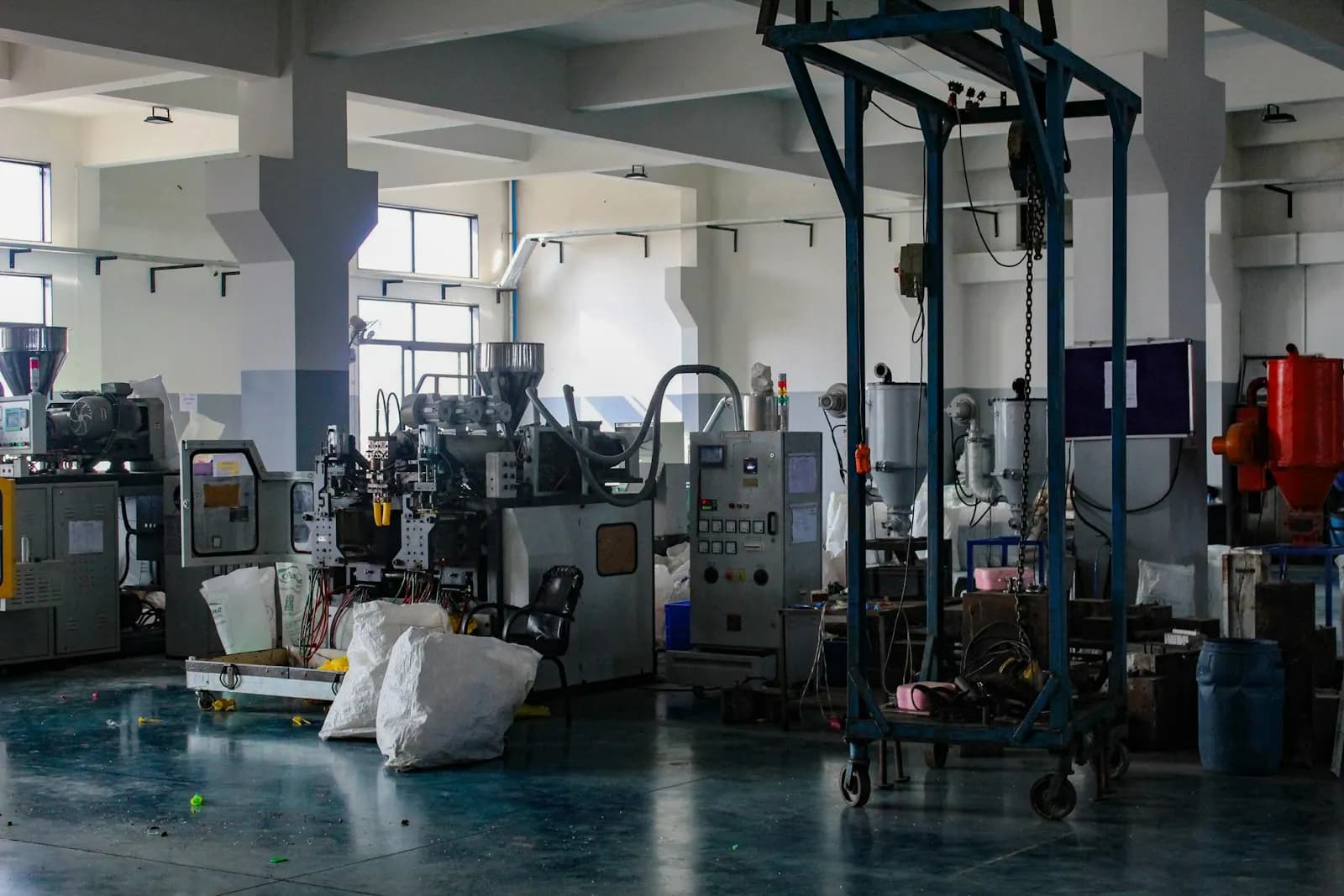 Plastic moulding and extrusion machines on the floor of a small manufacturing unit