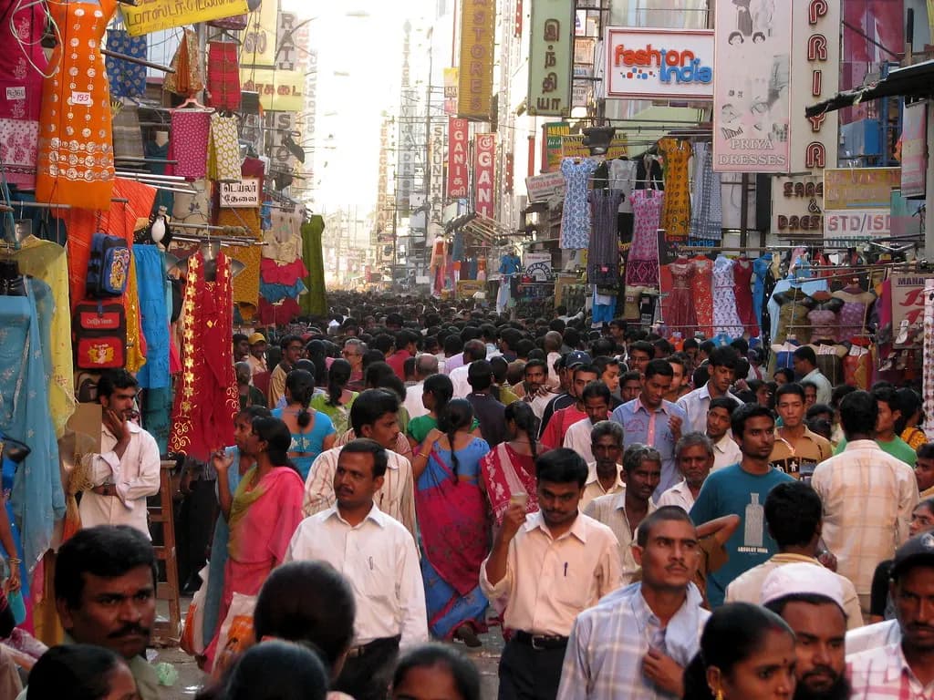 A crowded shopping street in T. Nagar, Chennai, lined with textile and garment shops
