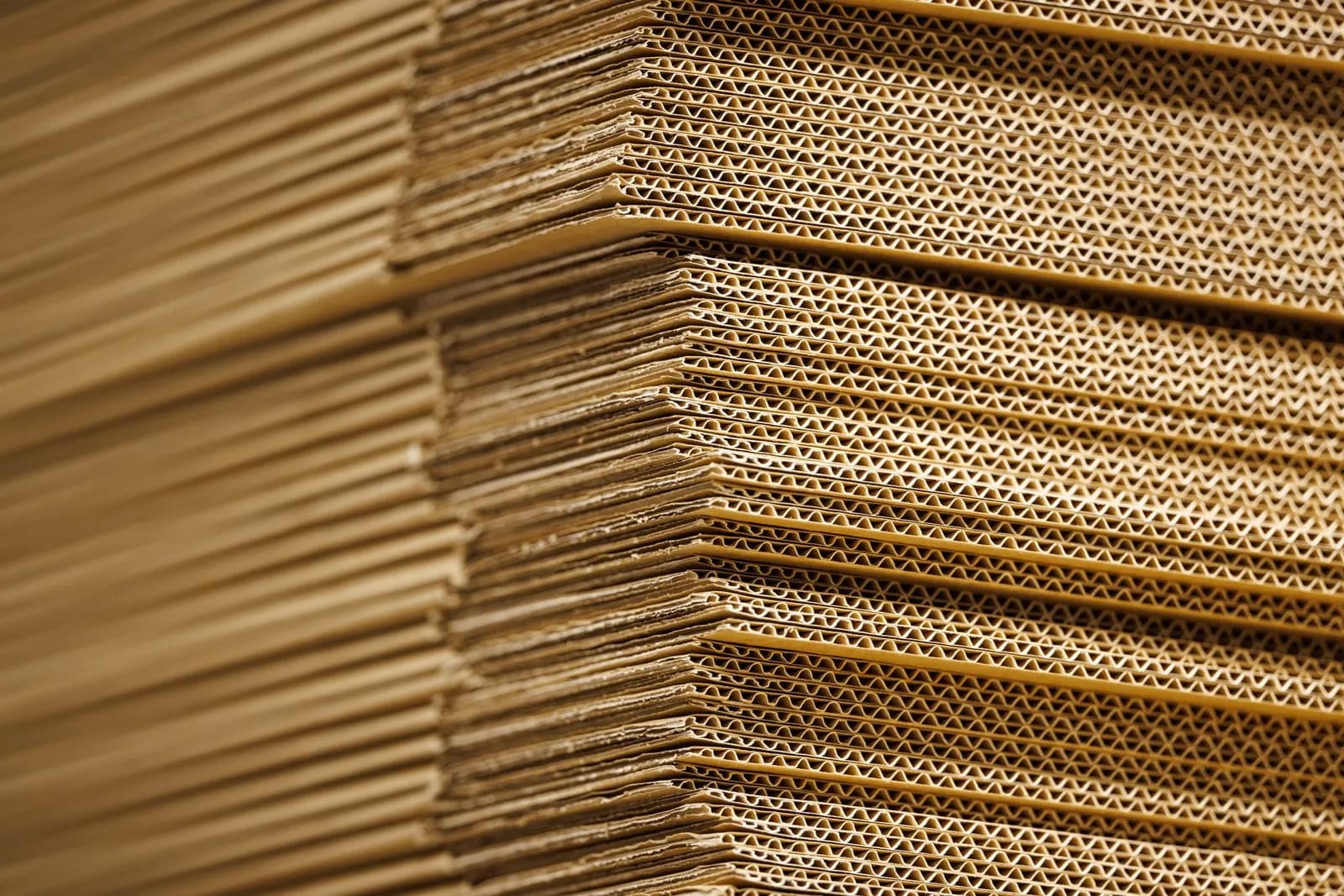 Stacks of flat corrugated cardboard cartons used for packing parcels