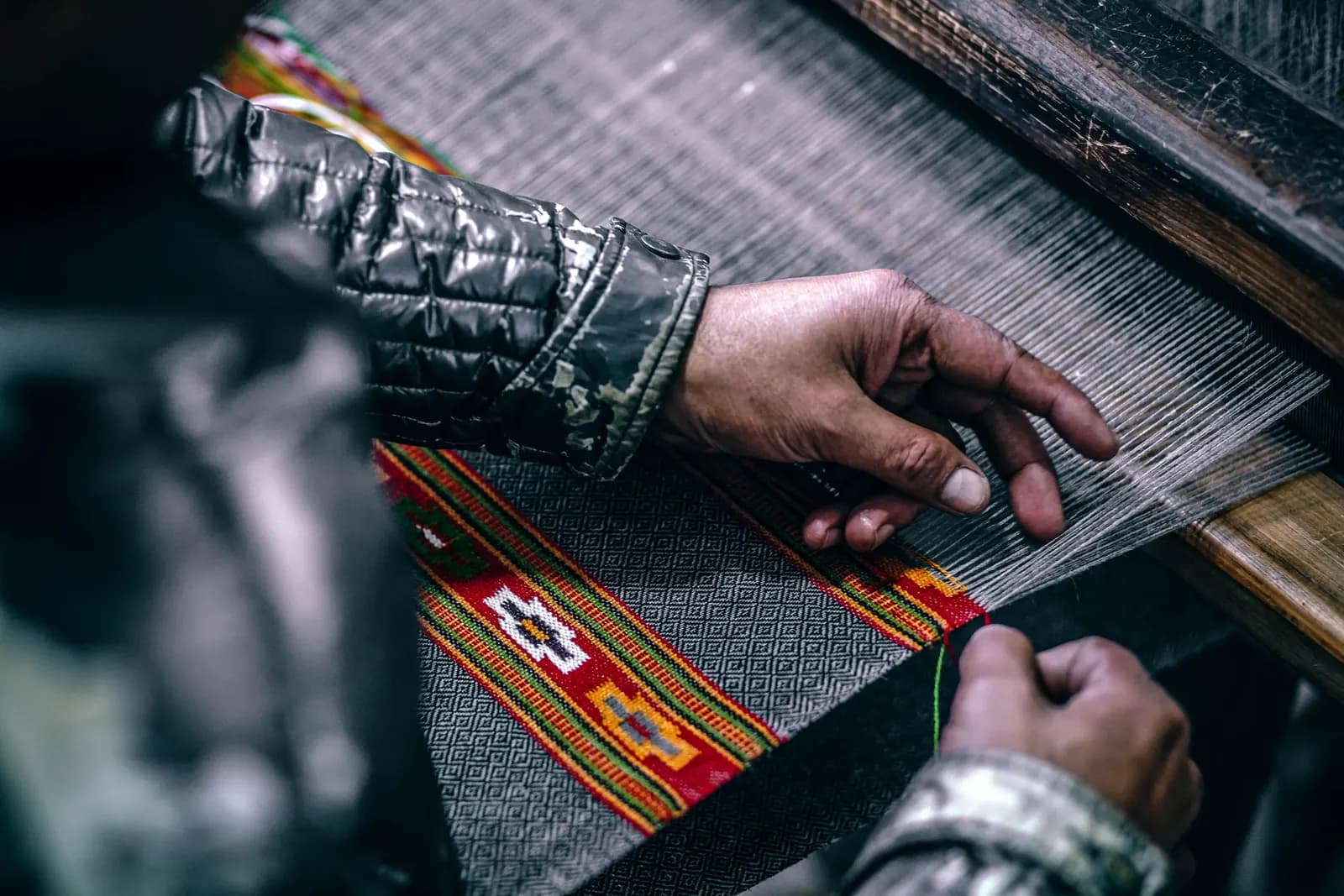 A worker stitching clothes on a sewing machine in a garment factory
