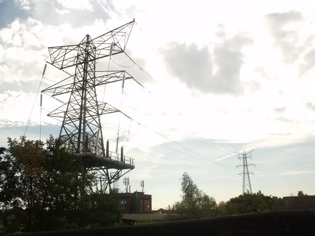 Electricity pylons and power lines crossing a suburban area of Birmingham