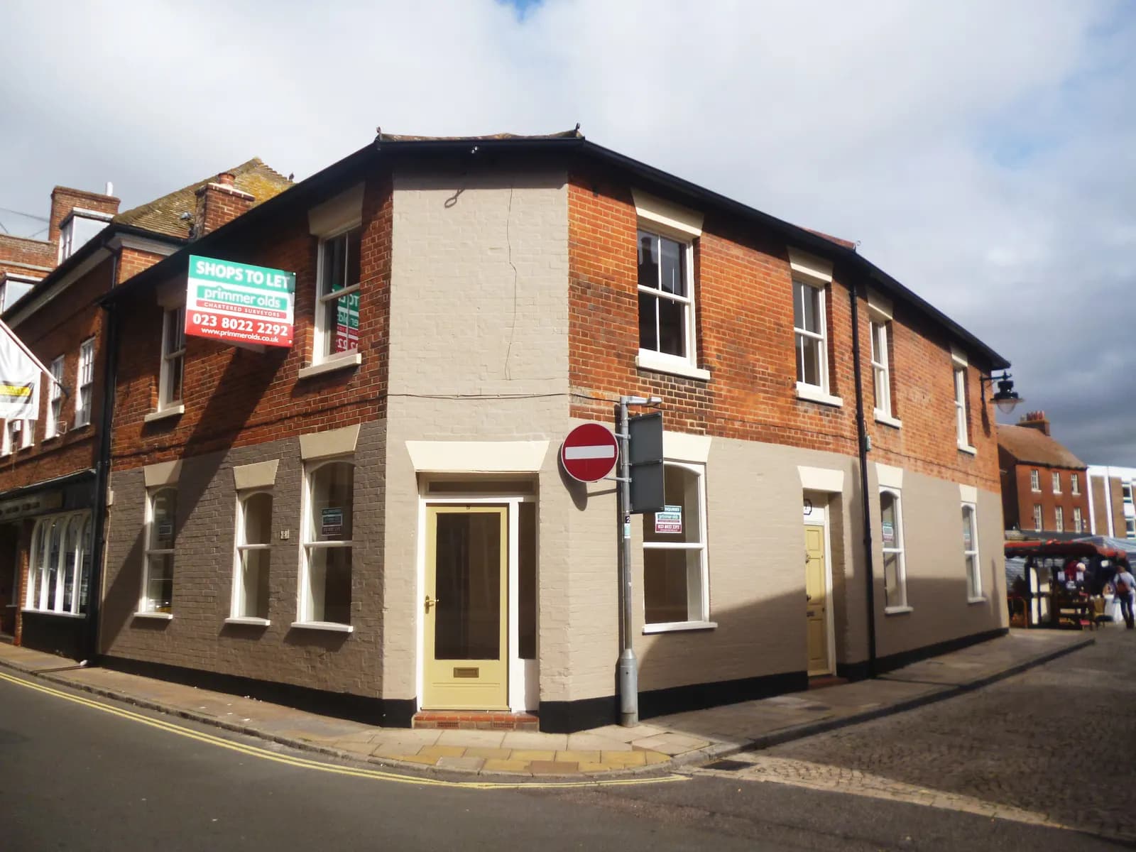 An empty shop unit with a To Let sign in its window