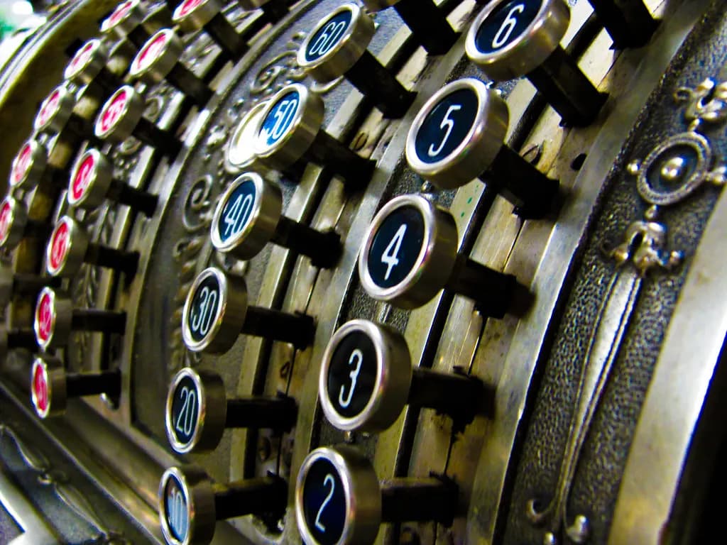 Close-up of the brass number keys on an old mechanical cash register