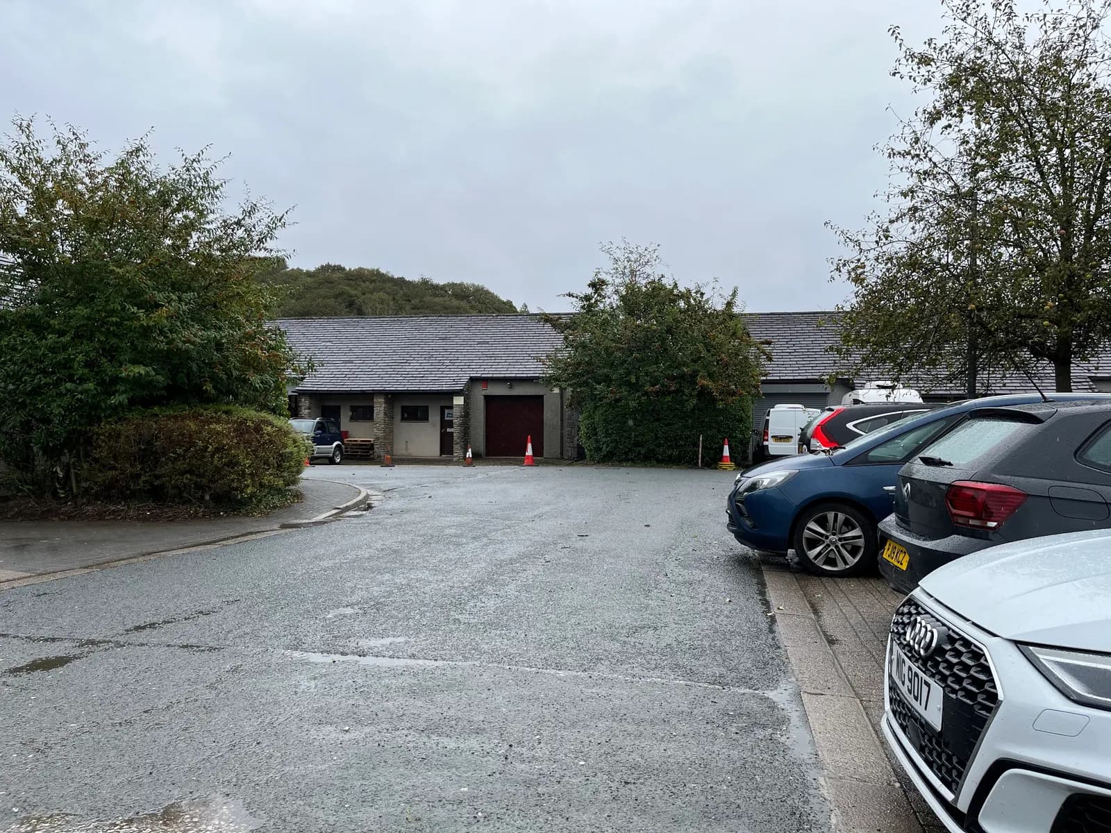 Cars parked outside low-rise offices at Crakeside Business Park on a wet day