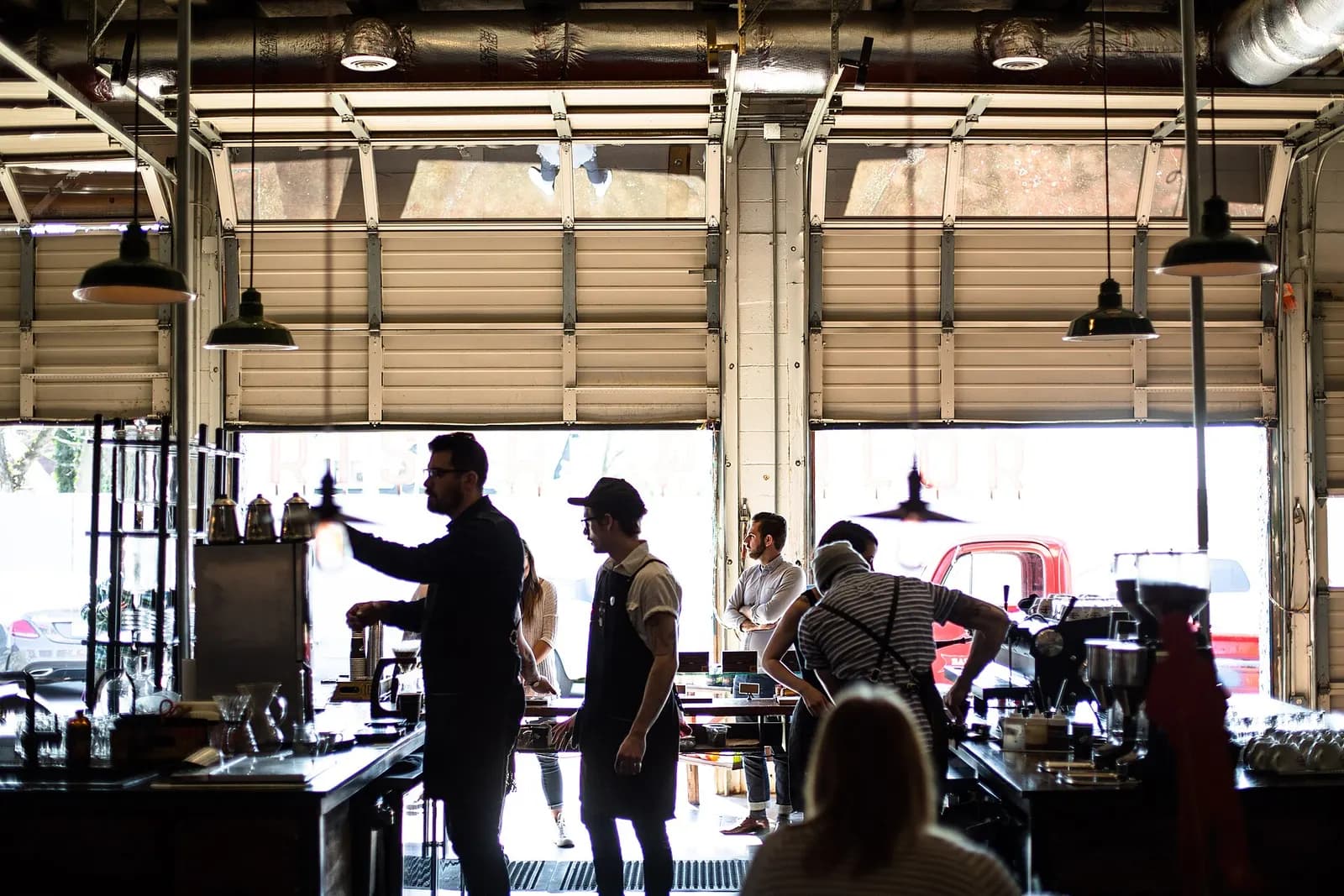 Baristas and staff working behind the counter of a busy independent coffee shop
