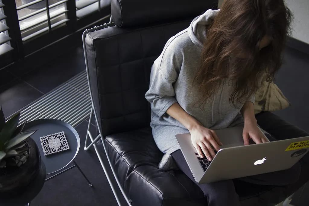 A woman using a laptop at home
