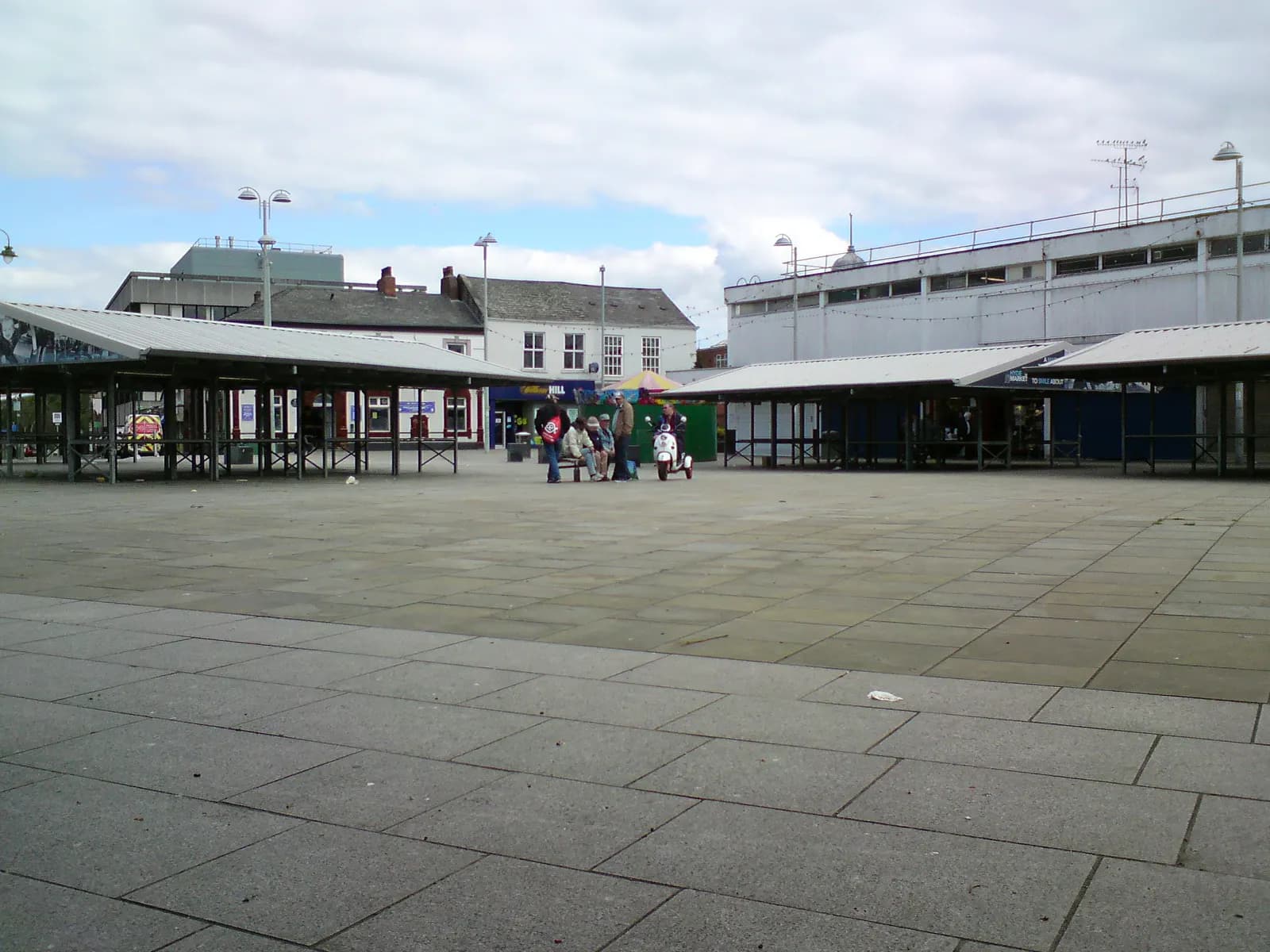 A market square with mostly empty stalls on a bank holiday Monday