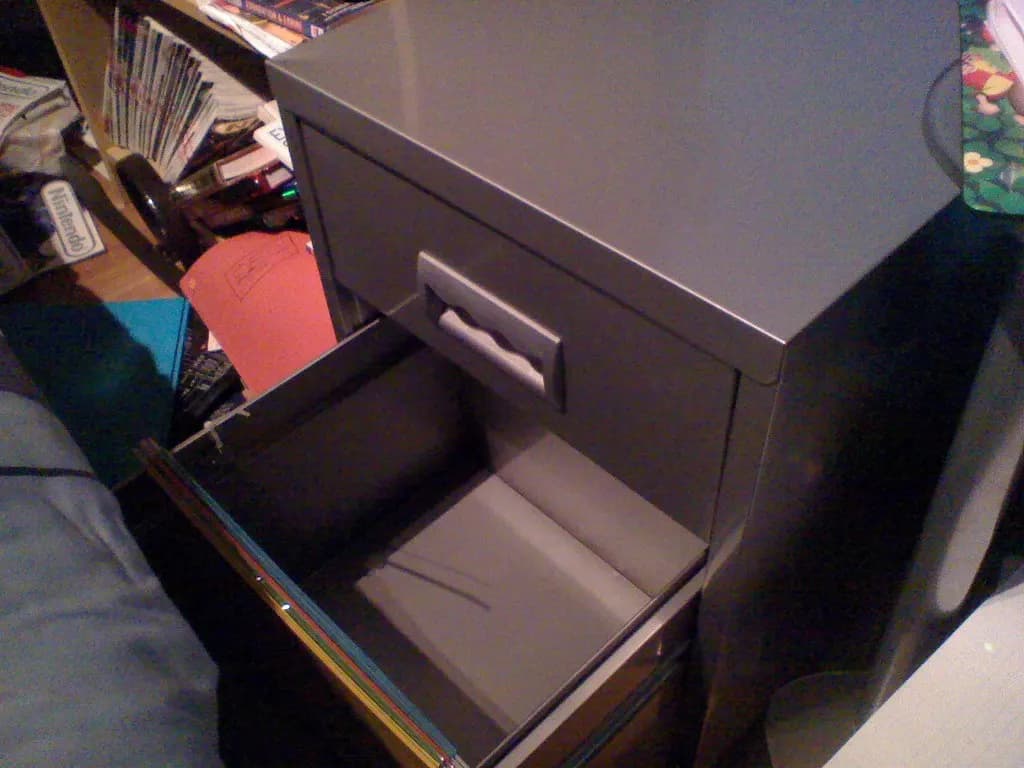An open filing cabinet drawer full of hanging files