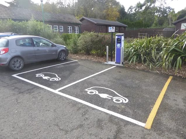 Two marked electric car charging bays with charge points in a car park in south-west Scotland