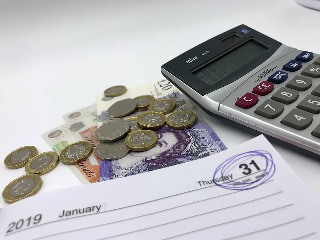 Diary page with 31 January circled next to sterling notes, pound coins and a calculator